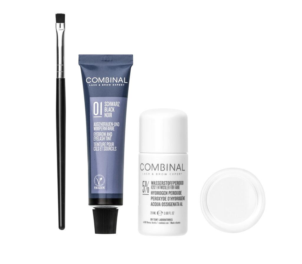 Cosmetics set featuring a black makeup brush, a blue Combinal eyelash tint tube, and two white bottles with caps on a white background.