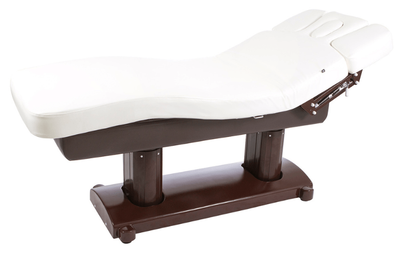 White padded massage table with a dark brown base and adjustable headrest at one end.