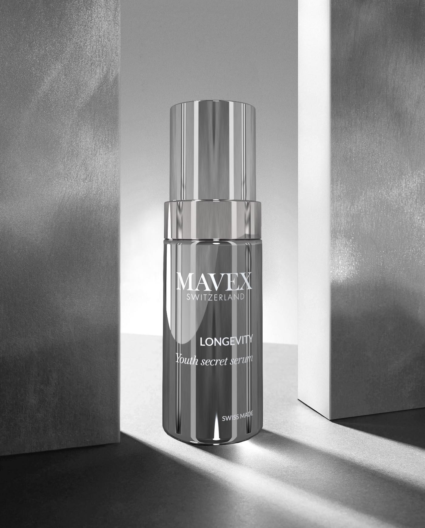 Mavex-longevity-secret-serum-30ml | ATE Bordeaux Shiny silver perfume-like bottle labeled 'MAVEX SWITZERLAND' and 'LONGEVITY' on a reflective surface between two tall gray blocks