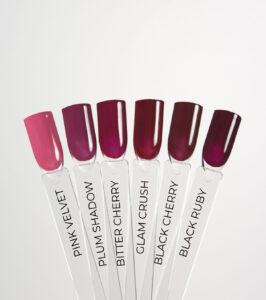 Fanned display of six nail polish swatches ranging from pink to dark burgundy, labeled Pink Velvet, Plum Shadow, Bitter Cherry, Glam Crush, Black Cherry, and Black Ruby.