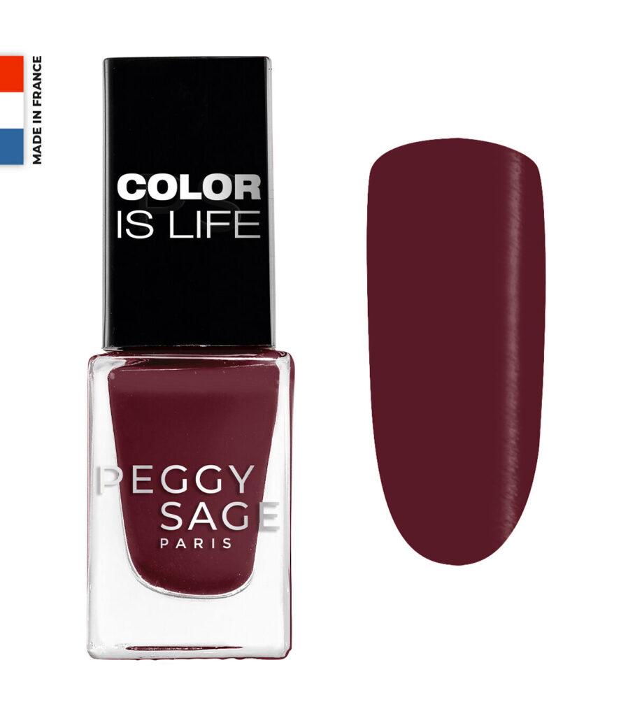 Burgundy nail polish bottle with black cap reading 'COLOR IS LIFE' and a burgundy swatch to the right; 'PEGGY SAGE PARIS' on the bottle, small 'MADE IN FRANCE' flag on the left.